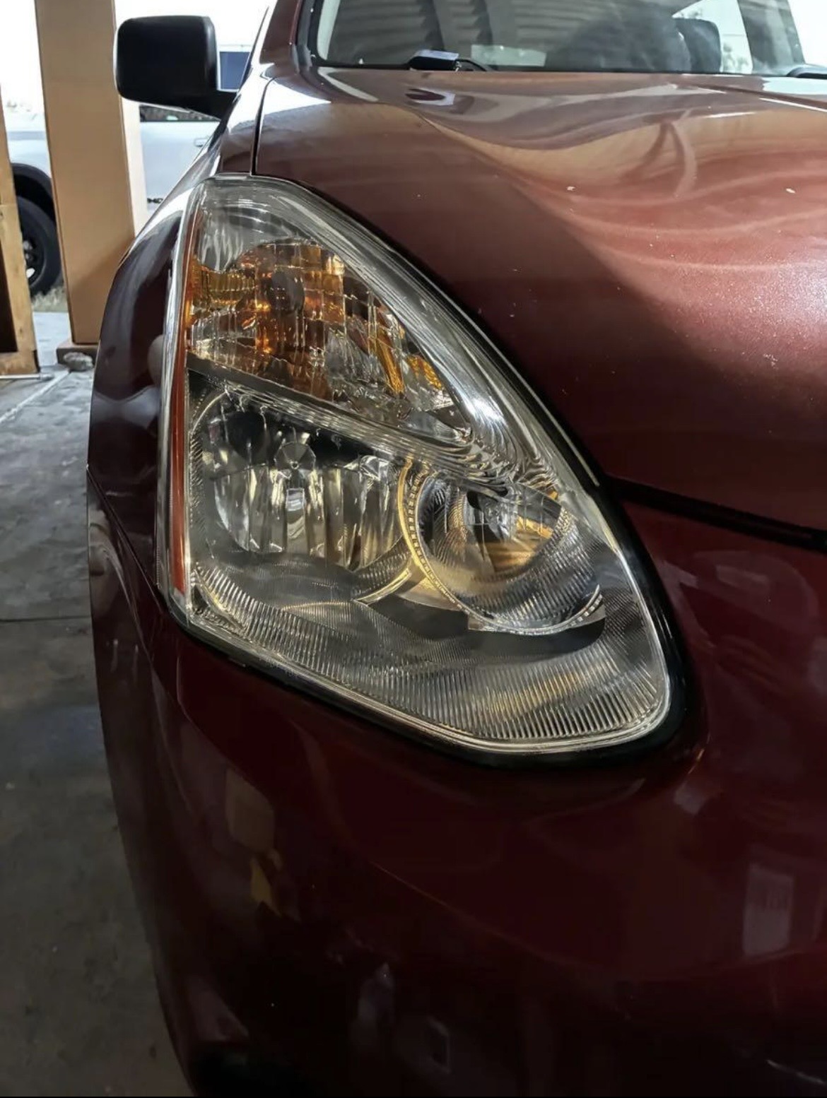 Same red sedan headlight fully restored to crystal clear factory clarity